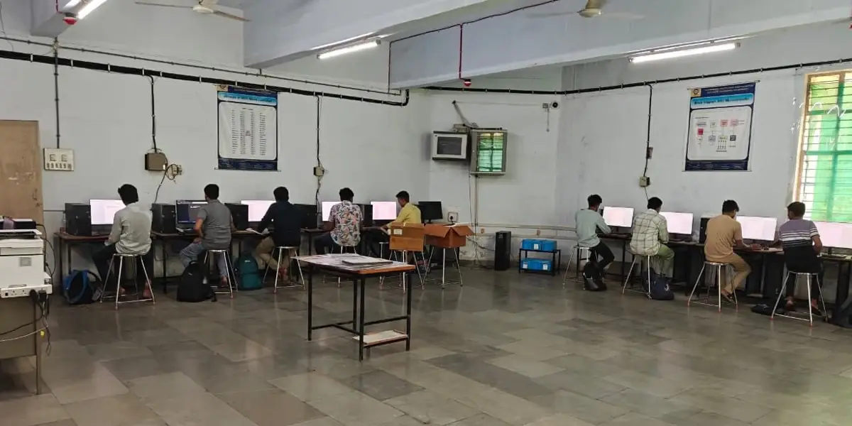 Overview of the computer lab with students working at individual workstations
