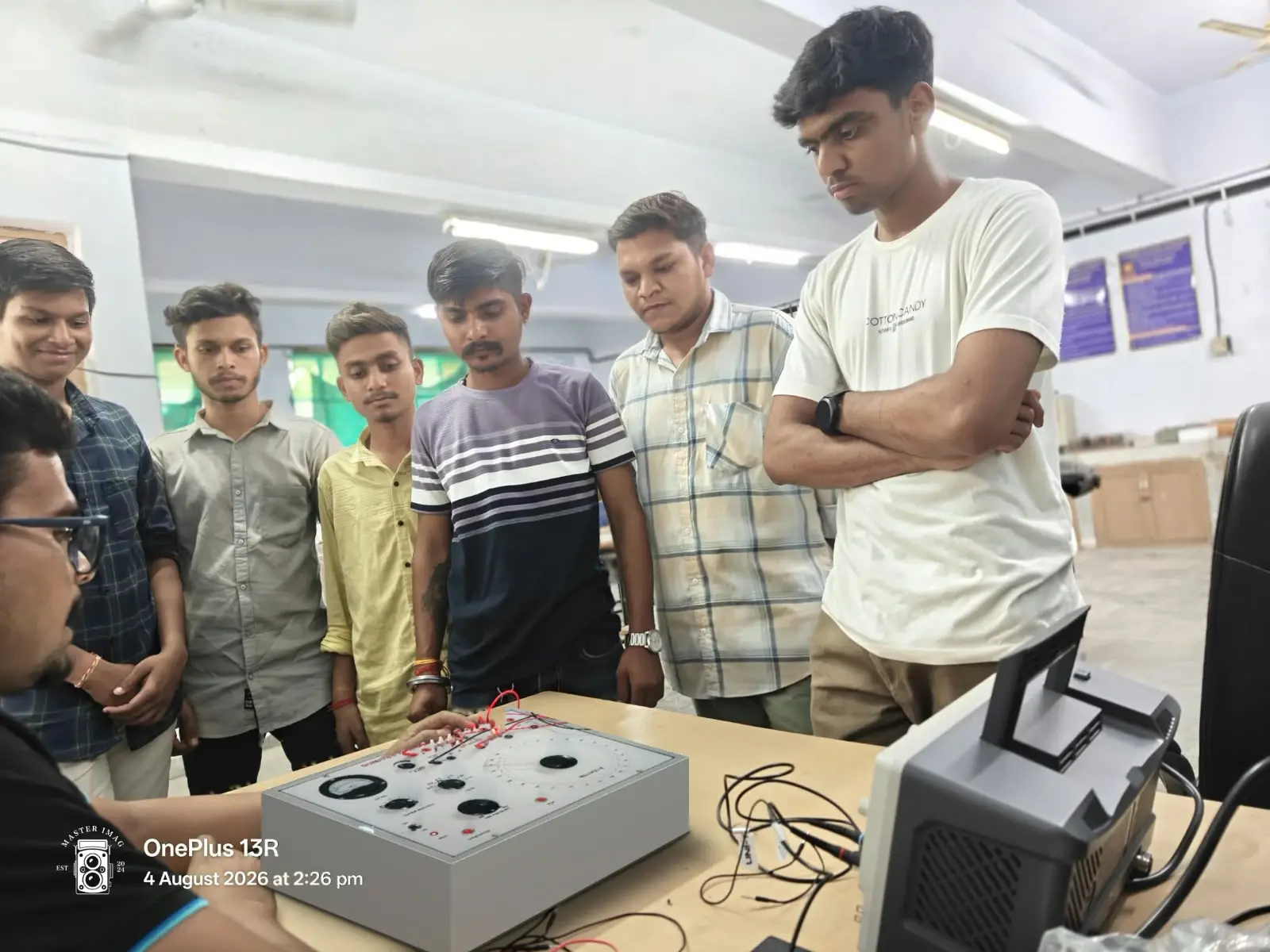 Faculty demonstrating instrumentation equipment to students
