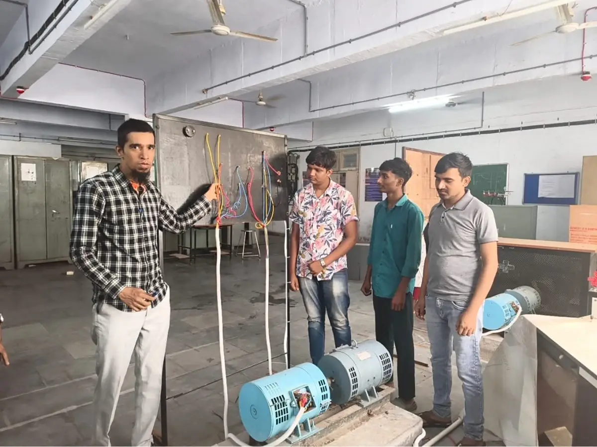 Faculty explaining the connection panel of the motor–generator set