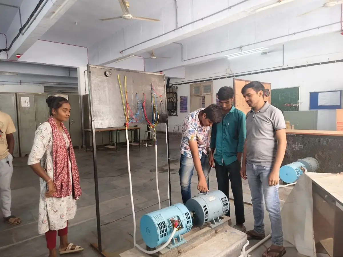 Students examining the machine set before performing the experiment
